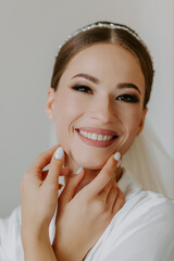 Portrait photo. Beautiful face of the bride, the bride holds her hands near her face