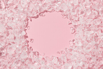 Close up crushed ice in sunlight on pink with copy space. Summer background refreshment concept