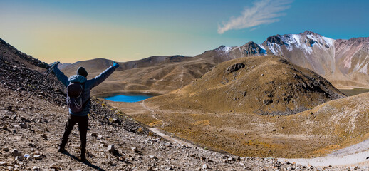 hiker on top of the mountain, panoramic view of the nevado de toluca crater