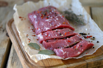 Fresh raw veal in paper. Farmed organic meat.