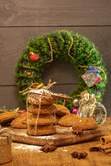 christmas composition, cookies, christmas wreath and gifts on a wooden background, holiday