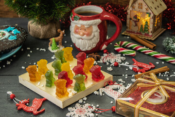 composition of christmas sweets and a cup of coffee on a wooden background