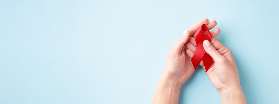 World AIDS Day banner with hands holding red ribbon