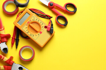 Flat lay composition with electrician's tools and accessories on yellow background, space for text