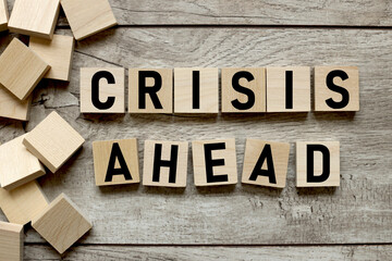 CRISIS AHEAD. the text of the wooden blocks near the wooden blocks are stacked one folk