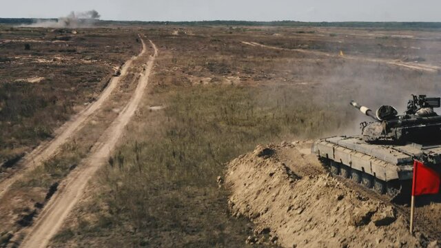 Military armored tank vehicle on battlefield shoot fire. Army training demonstration. Combat heavy war battle transport technology. Army force power. National defense and protection. Aerial drone shot