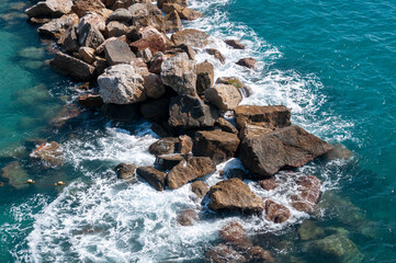 Beating sea waves against rocks. Top view.