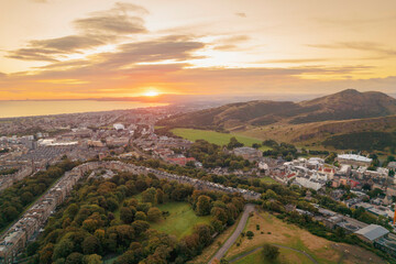 Fototapeta na wymiar Aerial sunrise view of Holyrood Park is the largest of Edinburgh's royal parks, climb to Arthur's Seat for stunning views of the city, explore the castle where Scottish kings lived or visit museums