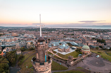 Aerial close-up view of cross Nelson Monument in Calton Hill, Edinburgh, Scotland. Large monument...