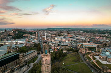 Fototapeta premium Aerial sunrise view of Nelson Monument in Calton Hill, Edinburgh, Scotland. Large monument to a famous military leader. When it was built, the Nelson Monument was the tallest structure in the world