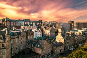 Obraz premium Aerial sunrise view of Calton Hill in Edinburgh, Scotland surrounded by old buildings. Locals use the hill to observe the vastness of the city, enjoy festivals, or attend to spiritual activities