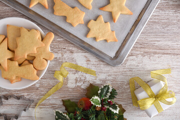 Table with freshly baked cookies and Christmas decoration top view