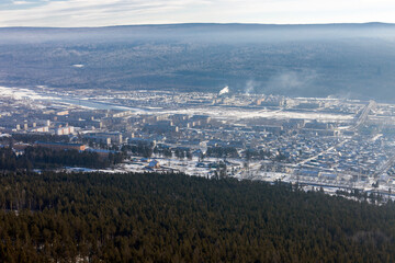 Siberian city of Ust-Kut on the Lena River among the taiga hills at the beginning of winter.