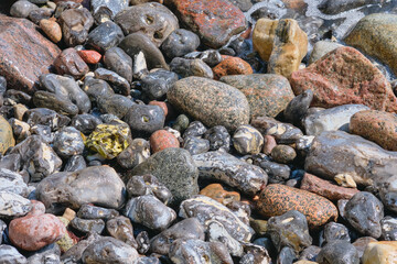 The rocky coast of the Baltic Sea and waves beat against stones.