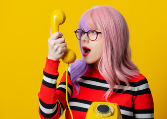Girl with purple hair and red sweater hold dial phone