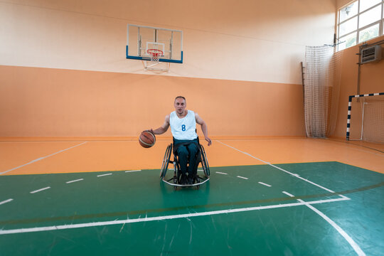 a photo of a war veteran playing basketball in a modern sports arena. The concept of sport for people with disabilities
