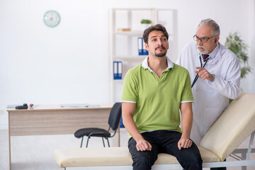 Young male patient visiting old male doctor