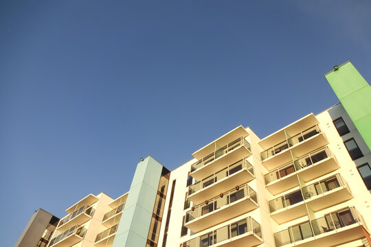 White modern apartments building facade in sunlight on a sunny day with clear blue sky. Vana - Kuuli street. Tallinn, Estonia, Europe. Nov 2021