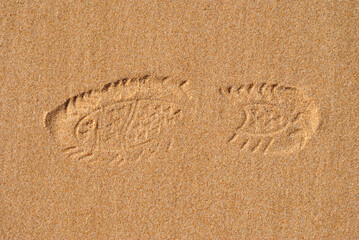 Close Up of Footprint of Shoe in Sandy Beach 