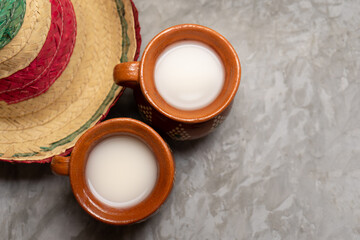 Mexican fermented beverage called pulque on a gray background