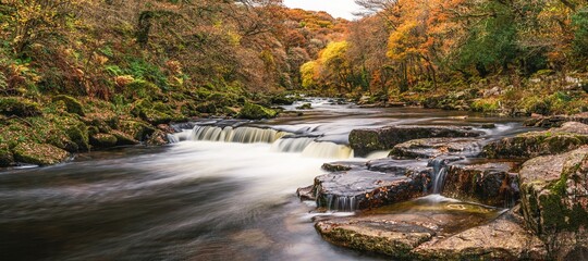 Autumn Colours over River Dart in long exposure, Dartmoor Park, Devon, England, Europe