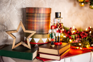 New Year's decor on a light shelf. a star, a gift and books with a nutcracker