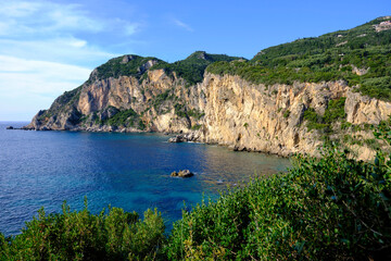Beach with stone walls at Paleokastritsa, Corfu Island, Greece