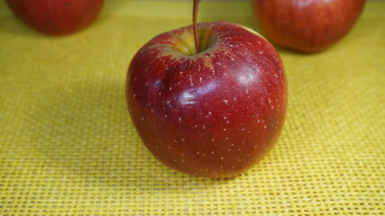red apple on a yellow background