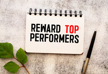 Reward top performers text memo written on a white background with pencils