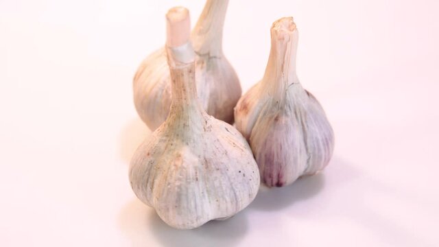 rotating garlic head on wite background.