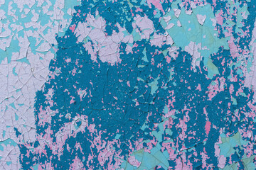 Peeling paint on the wall. Old concrete wall with cracked flaking paint. Weathered rough painted surface with patterns of cracks and peeling. High resolution texture for background and design. Closeup