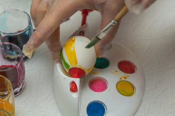 Close up view of man painting Easter eggs with special utensils. Holiday concept. Sweden. 