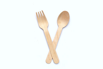 Wooden spoon and fork on white background.