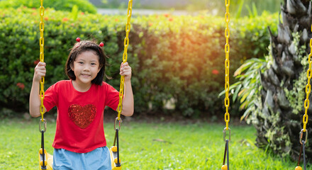 chinese children playing swing, kids have fun with playground, happy girl