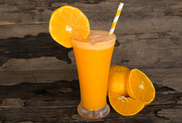 Orange juice fruit smoothies yogurt drink yellow healthy delicious taste in a glass slush for weight loss on wooden background.