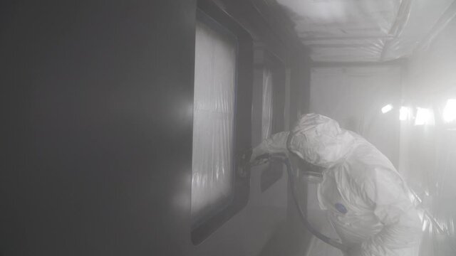 The shipyard masters paint the ship perfectly with the spray paint gun