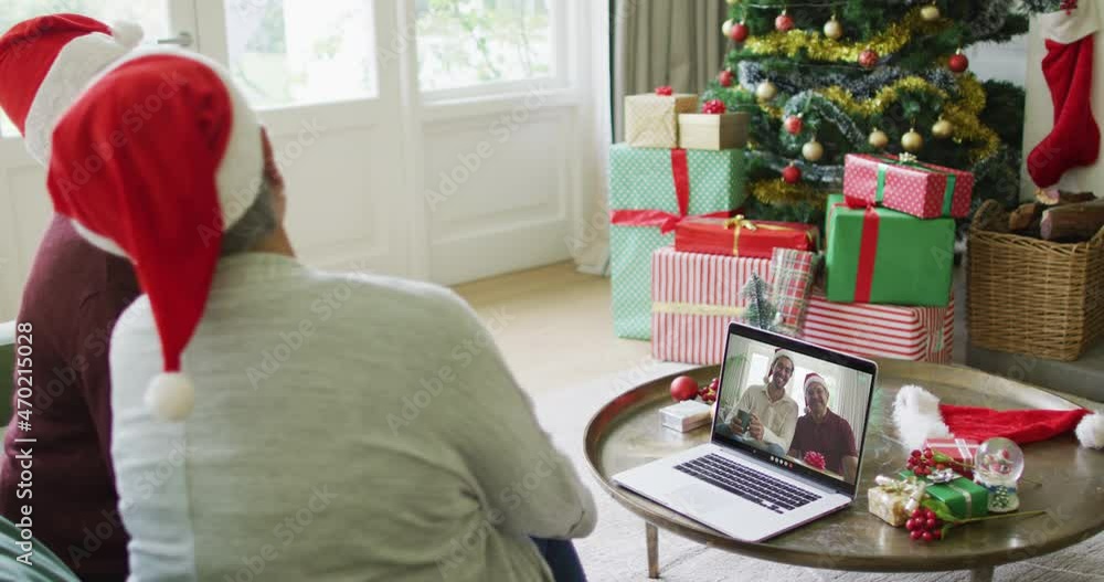 Canvas Prints Diverse senior female friends using laptop for christmas video call with happy family on screen