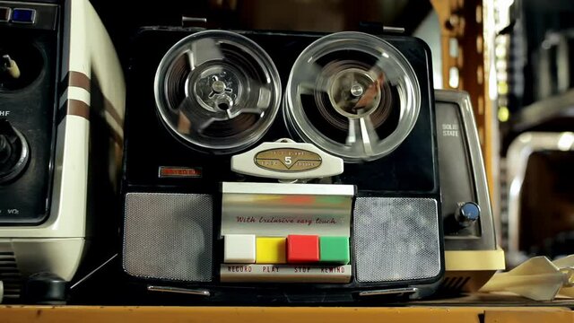 Vintage Reel-to-reel Tape Recorder Circa 1967 inside an Antique Store. Closeup. 4K Resolution.