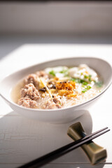Thai style clear soup rice noodle in traditional bowl. Selective focus