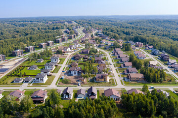 Aerial view of a cottage village on the edge of an endless forest in Siberia