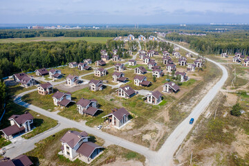 Aerial view of a cottage settlement under construction in the forest in Siberia