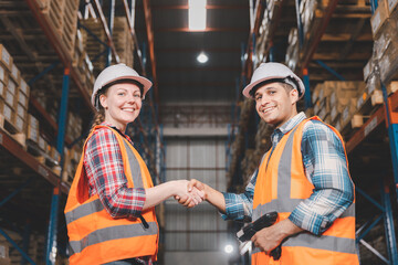 Two logistic staff hand shake at warehouse