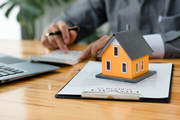 Buying a Home or Insurance, an insurance agent explains the lease agreement to a client before making a contract. Mortgage loan approval home loan and insurance concept.