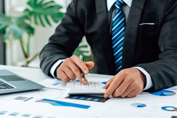 Close up of accountant or banker checking investment results, calculates financial savings,...
