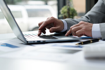 businessman typing on a laptop in a coworking space