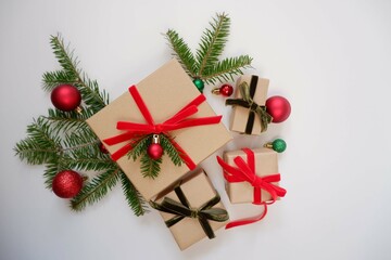 Christmas background with gift boxes and ornaments in white color. Xmas celebration, greetings, preparation for winter holidays. Festive mockup, top view, flat lay with copy space.