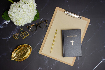 White hydrangea with bible and golden leaves with glasses.