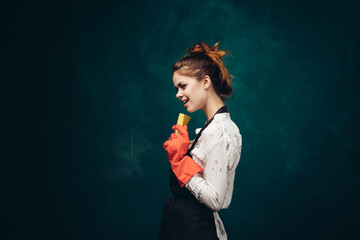 Fototapeta premium cleaning lady in red rubber gloves with a rag in her hands housekeeping