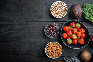 Healthy products immunity boosters , flat lay with space for text, on black wooden background