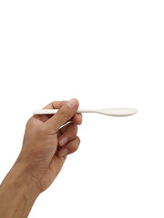 Hand holding white plastic spoon isolated on white background.